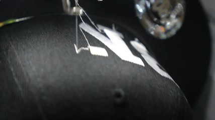 Automatic Sewing Machine Stitching Lettering On Cap. Closeup. HD, 1920x1080. 
