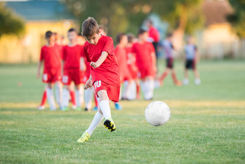 Kids soccer football - children players match on soccer field