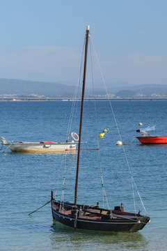 old wooden sailboat moored near the shore