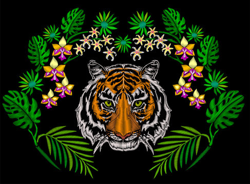 Tiger in the jungle embroidery for clothing decoration symmetrical ornament with exotic flower and palm leaves.