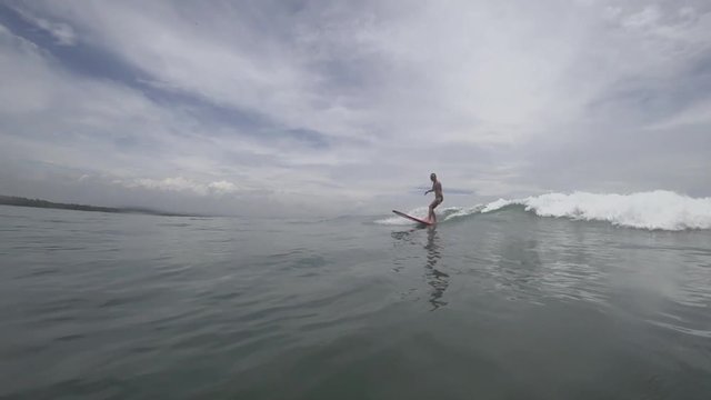 Surfer girl on a wave, slow motion,120ps/sec