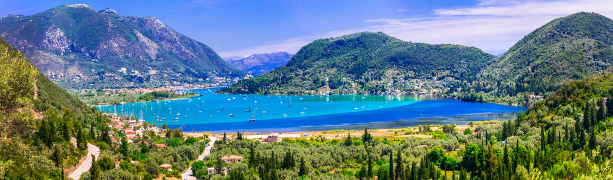 Nidri bay Lefkada 13k panorama of green islands and turquoise sea in Greece. Scenic Ionian islands view of majestic mountains and luxury yachts in harbor. Mediterranean travel scenery
