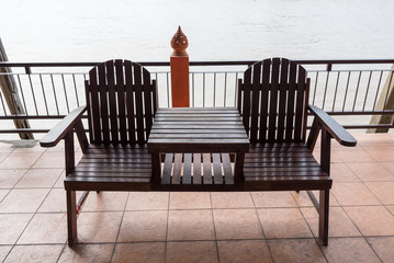Wooden bench backside the river in thailand.