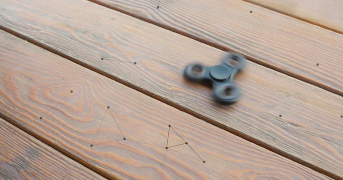 hand spinner, or fidgeting spinner, rotating in hand with animation