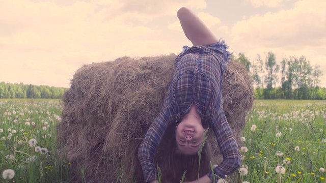 Young woman falling down from haystack