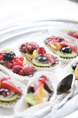 wedding catering on silver plates. small fruits on silver tray
