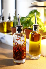 bottles of oil and vinegar on a wooden table