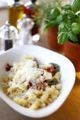 Pasta dish in an oval plate, in the restaurant on a wooden table