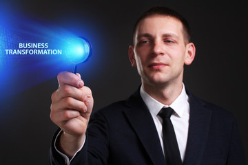 The concept of business, technology, the Internet and the network. A young entrepreneur working on a virtual screen of the future and sees the inscription: Business transformation