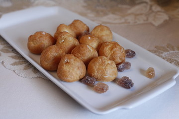 traditional carnival food served on a white plate with candy cane