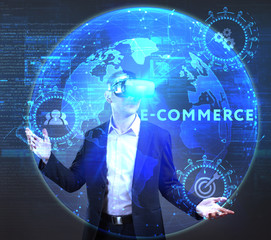 The concept of business, technology, the Internet and the network. A young entrepreneur working on a virtual screen of the future and sees the inscription: E-commerce