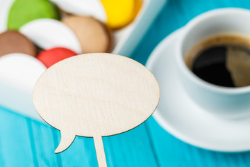 Wooden empty plate, macaroons, coffee