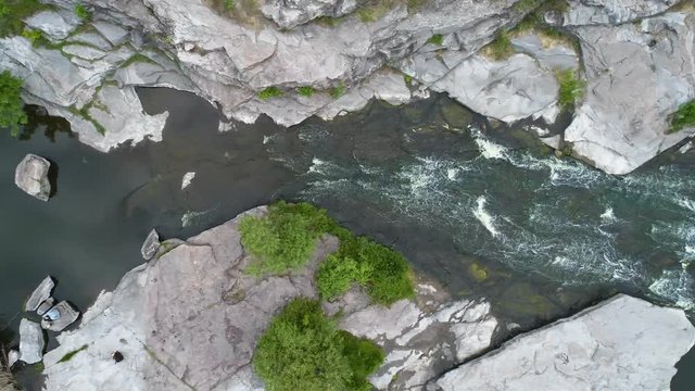 Aerial footage. Fly over river rapids on rocks