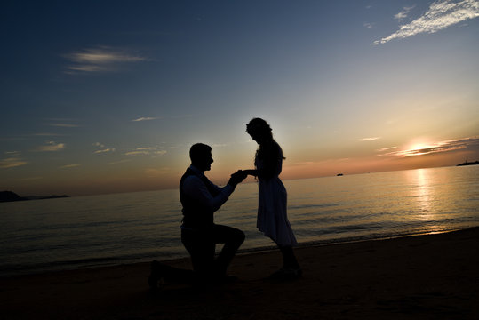 Silhouette couple on the beach with sunset