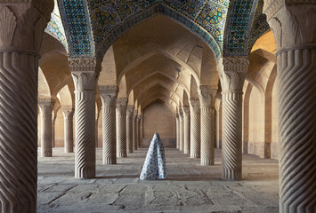 Woman in Veil Standing Between Carved Columns of Vakil Mosque in Shiraz