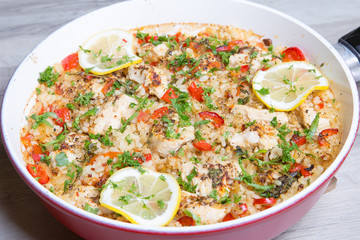 Paella with chicken, tomatoes and pepper . Traditional Spanish dish. Selective focus