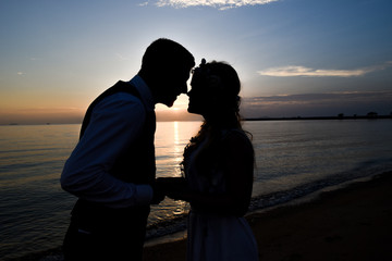 Silhouette couple on the beach with sunset