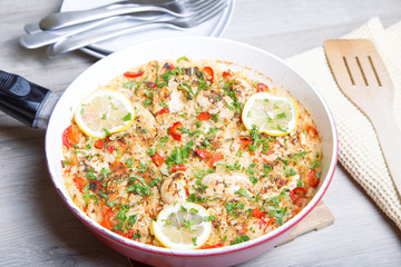 Paella with chicken, tomatoes and pepper . Traditional Spanish dish. Selective focus