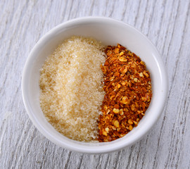 Cayenne pepper and sugar in bowl on table