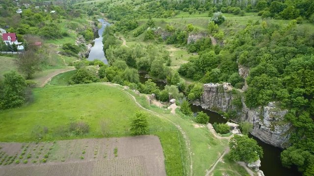 Aerial footage. Fly above village and river canyon buki