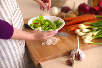 Young Woman Cooking in the kitchen. Healthy Food