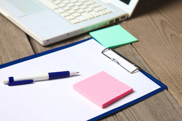 blank notebook on wooden table with pencils