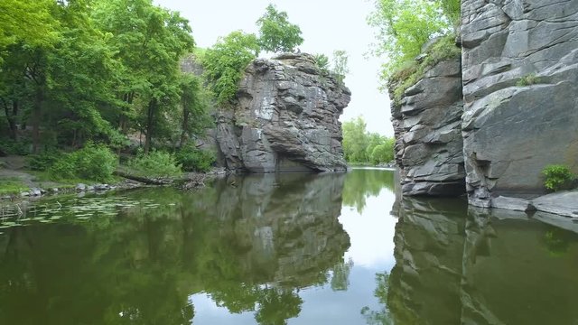 Arial footage. Low fly above water in canyon