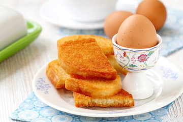 Boiled eggs and toasts for breakfast