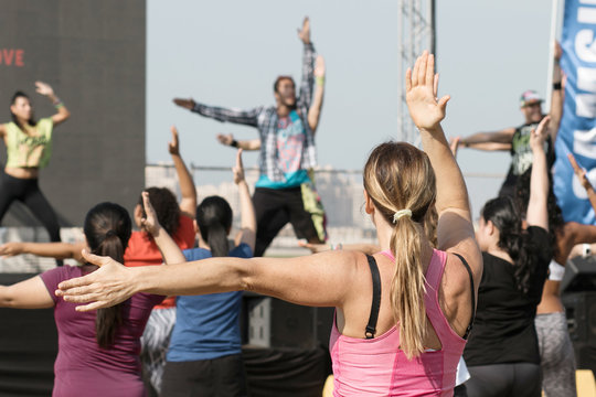 Young Woman Doing Fitness  With Trainer Outdoor