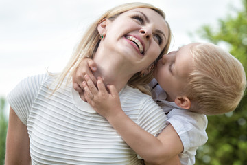 Fototapeta premium Life moment of happy family!Little boy tenderly embraces his mother.