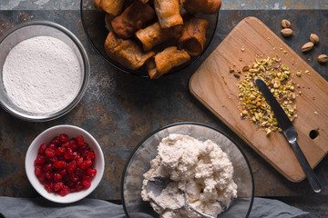 Cannoli with ingredients for filling on the stone background top view