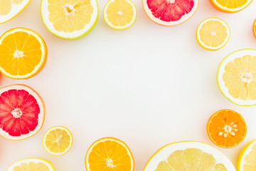 Frame made of citrus fruits on white background. Flat lay, top view. Fruit's background