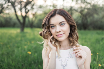 Naklejka premium Portrait of a beautiful girl in the garden