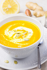 Pumpkin soup puree in a bowl on marble background. 