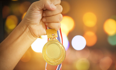 Business winner holding medal gold award to colorful background