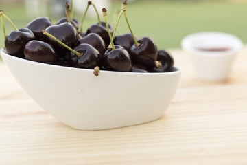 White bolw  with ripe cherries