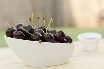 White bolw  with ripe cherries