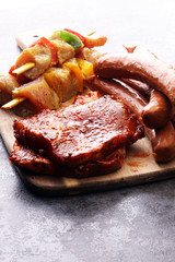 Selection of marinaded meat for bbq grilling with herbs on table