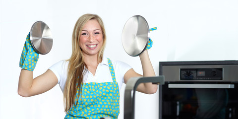 Happy baking cooking woman in her kitchen 