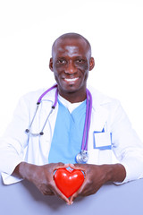 Male doctor with red heart and blank sign isolated on white back