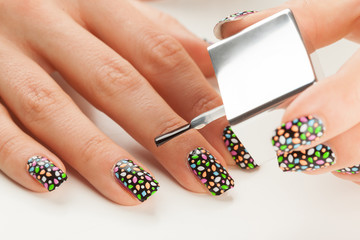 Beautiful manicure process. Nail polish being applied to hand