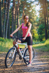 Fototapeta premium cyclist cycling mountain bike on Pine forest trail