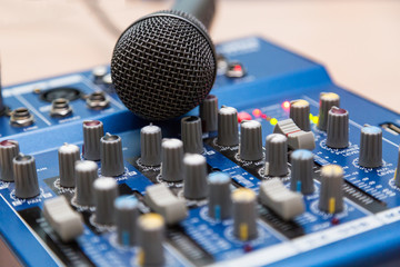 The equipment for recording. Microphone lying on sound mixing Board.