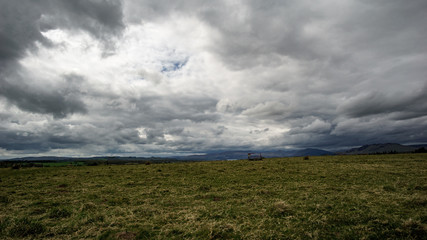 Ultra wide landscape with empty hay cart.