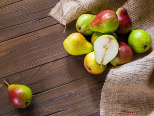 Pears on a wooden background and burlap