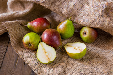 Pears on a wooden background and burlap