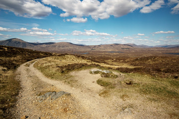 Scottish hiking path in front of beautiful landscape.