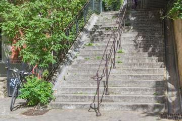 Paris, typical staircase with a parked bike on the rail