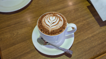 A cup of cappucino on the wood table