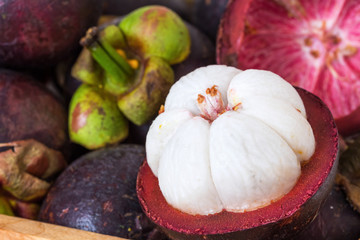 Mangosteen flesh, top view.Mangosteen and cross section showing the thick purple skin and white flesh of the queen of friuts,